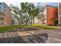 Beautifully landscaped grounds adorn this orange condominium building, providing a serene outdoor setting at 6960 20Th N Ave # 306, St Petersburg, FL 33710