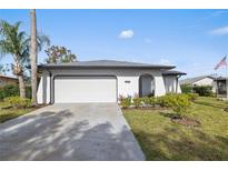 Updated single story home with a two car garage and landscaped lawn at 8209 Rugby Ct, Hudson, FL 34667