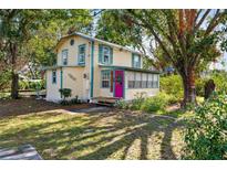 Charming yellow house with green shutters, and a well-manicured lawn at 1505 18Th W St, Bradenton, FL 34205