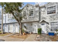 Inviting exterior of a townhome with landscaping and a welcoming entrance at 6691 121St Ave # D, Largo, FL 33773