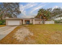 Single-story house with attached garage, landscaping, and a spacious front yard at 1803 Southwood Ln, Clearwater, FL 33764