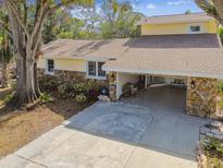 Split-level home with stone accents and a two-car garage at 6034 17Th N Ave, St Petersburg, FL 33710