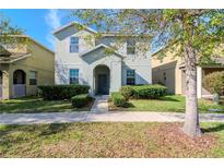 Charming two-story home with manicured landscaping and a welcoming entrance at 13419 Lake Monroe Pl, Riverview, FL 33579