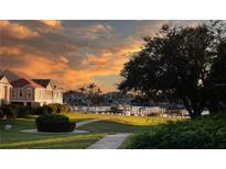 Stunning waterfront view with lush landscaping, dock, and beautiful sunset, providing serene and picturesque scenery at 21 Crescent S Pl, St Petersburg, FL 33711
