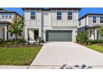 Charming two-story home with a manicured front yard and a two-car garage and a concrete driveway at 6233 Golden Beach Dr, Apollo Beach, FL 33572