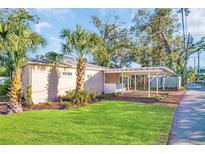 Charming single-story home featuring a covered area and vibrant green lawn at 2514 Ohio S Ct, Gulfport, FL 33707