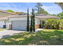Charming single-story home featuring an attached garage, blue entry door, and well-manicured front lawn at 3611 19Th N St, St Petersburg, FL 33713