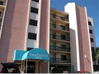 View of Sand Castle III condos with a covered entrance and multiple floors of units with private balconies at 20040 Gulf Blvd # 302, Indian Shores, FL 33785