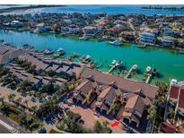 Stunning aerial view of waterfront townhomes with private boat docks and easy access to the bay and gulf at 732 Pinellas Bayway S, Tierra Verde, FL 33715