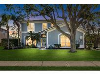 Charming two-story home features a well-manicured lawn, mature trees and tasteful landscaping at 1600 Gray Bark Dr, Oldsmar, FL 34677