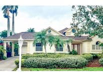 Charming single-Gathering home with lush landscaping, well-manicured lawn, and porte-cochere at 4531 Swordfish Dr, Bradenton, FL 34208