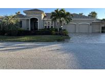 Charming single-story home featuring a well-manicured front lawn and three-car garage at 10626 Restoration Ter, Bradenton, FL 34212