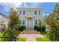 Charming two-story home features a welcoming entrance with brick steps and beautifully maintained landscaping at 100 37Th Ne Ave, St Petersburg, FL 33704