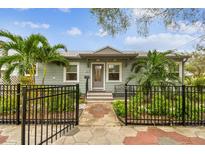 Charming home with a well-manicured yard, a decorative fence, and walkway leading to the front door at 487 9Th N Ave, St Petersburg, FL 33701