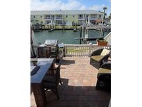 Cozy waterfront patio with a grill and seating, perfect for outdoor entertaining and enjoying scenic views at 5215 Coquina Key Se Dr # A, St Petersburg, FL 33705