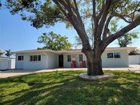 Charming single-story home with a spacious front yard and mature shade trees, perfect for outdoor enjoyment at 2308 Victory Ave, Largo, FL 33770