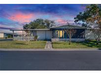 Charming single-story home featuring a screened porch, carport, and well-maintained landscaping in a lovely community at 3022 Short Leaf St, Wesley Chapel, FL 33543