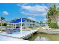 Charming waterfront condos featuring a dock with seating area and covered outdoor dining at 300 Venetian Dr # 7, Clearwater, FL 33755