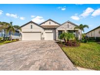 Charming single-Gathering home featuring a paved driveway and two-car garage at 19891 Bridgetown Loop, Venice, FL 34293