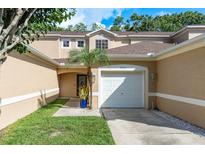 Inviting townhouse featuring a one car garage, neutral paint, and well-maintained landscaping at 8907 Casablanca Way, Tampa, FL 33626