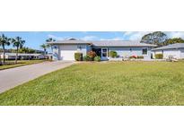 Charming one-story home with a well-maintained lawn and a single-car garage at 1613 Heather Pl, Palm Harbor, FL 34684