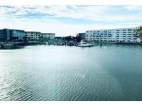 Scenic waterfront view featuring building complex and boat docks against blue skies and tranquil waters at 5940 30Th S Ave # 209, Gulfport, FL 33707