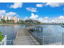 Scenic waterfront view with a private pier extending into the canal, offering boat access at 19029 Us Highway 19 N # 26-304, Clearwater, FL 33764