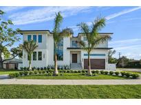 Beautiful two-story house featuring modern design, lush lawn, and professional landscaping at 5038 W Dickens Ave, Tampa, FL 33629