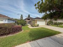 Charming single-story home with a well-manicured lawn, driveway, and attached garage, perfect for suburban living at 1604 Boswell Ln, New Port Richey, FL 34655