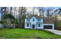 Beautiful two-story home with well-manicured lawn, mature trees, and a two car garage at 19018 Geraci Rd, Lutz, FL 33548