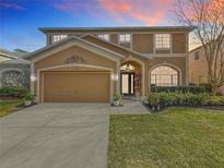 Charming two-story home with a well-manicured lawn, two car garage, and a welcoming front entrance at 27500 Breakers Dr, Wesley Chapel, FL 33544