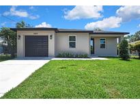 Charming single-story home featuring a well-maintained lawn, new driveway, and a convenient attached garage at 10019 N Hyaleah, Tampa, FL 33617