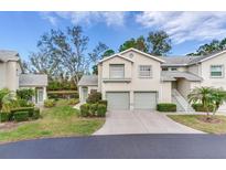 Well-maintained exterior of a two-story home with a two-car garage, manicured lawn, and lush landscaping at 6303 Green Oak Cir, Bradenton, FL 34203