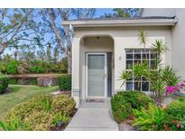Inviting front entrance with lush landscaping and a charming view of the adjacent pond at 6303 Green Oak Cir, Bradenton, FL 34203