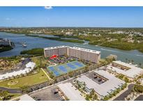 Waterfront condo with tennis courts, beautiful river views, and lush landscaping create a resort-like atmosphere at 19451 Gulf Blvd # 204, Indian Shores, FL 33785