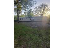 Single story home featuring a covered front porch and spacious lawn at 1463 Bobolink St, Zephyrhills, FL 33540