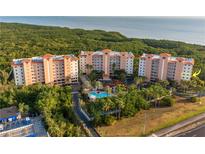 Scenic view of condominiums surrounded by lush vegetation with glimpses of the ocean in the background at 12077 Gandy N Blvd # 344, St Petersburg, FL 33702