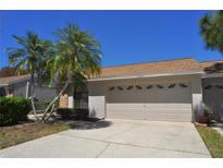 Charming single-story home with a two-car garage and well-maintained landscaping at 5581 Salem Square S Dr, Palm Harbor, FL 34685