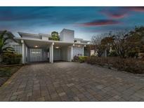 Charming single Gathering home with a two-car carport featuring a stylish brick driveway and unique facade at 800 Madonna Blvd # 2, Tierra Verde, FL 33715