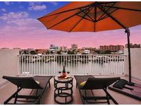 Charming roof deck with chairs, umbrella, and waterfront views offering a perfect retreat at 145 Brightwater Dr # 2, Clearwater, FL 33767