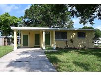 Charming home featuring a covered entry and well-maintained front yard landscaping at 11798 104Th St, Largo, FL 33773