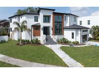 Stunning modern home with a landscaped yard and striking architectural details at 2622 N Dundee St, Tampa, FL 33629