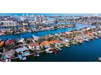 Waterfront property with private boat dock, swimming pool, and tropical landscaping in a desirable location at 301 Midway Is, Clearwater Beach, FL 33767