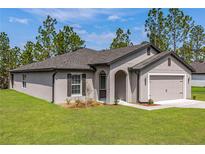 Charming single-story home featuring a two-car garage, arched entryway, and neatly manicured lawn at 7220 Swartburg Rd, North Port, FL 34291