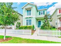 Charming two-story home with a picket fence and a well-manicured front yard at 11125 Winthrop Lake Dr, Riverview, FL 33578