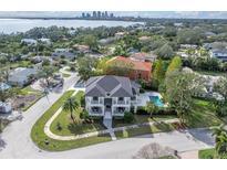 A beautiful home with a pool is seen from above, with a water view and a clear view of the city skyline at 200 Cordova Ne Blvd, St Petersburg, FL 33704