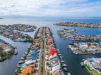 Stunning aerial view of waterfront homes and deep sailboat water in a vibrant coastal community near the ocean at 861 Symphony Isles Blvd, Apollo Beach, FL 33572