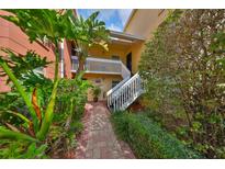 Charming condo building with lush landscaping and inviting entrance staircase for a welcoming ambiance at 2424 W Tampa Bay Blvd # B201, Tampa, FL 33607