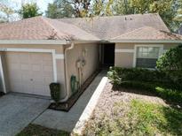 Charming single-story home with a well-maintained front yard and attached garage at 35324 Whispering Pines Dr, Zephyrhills, FL 33541