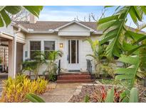 Charming home featuring a brick entryway and lush tropical landscaping adding curb appeal at 17 Venetian Ct, Tarpon Springs, FL 34689